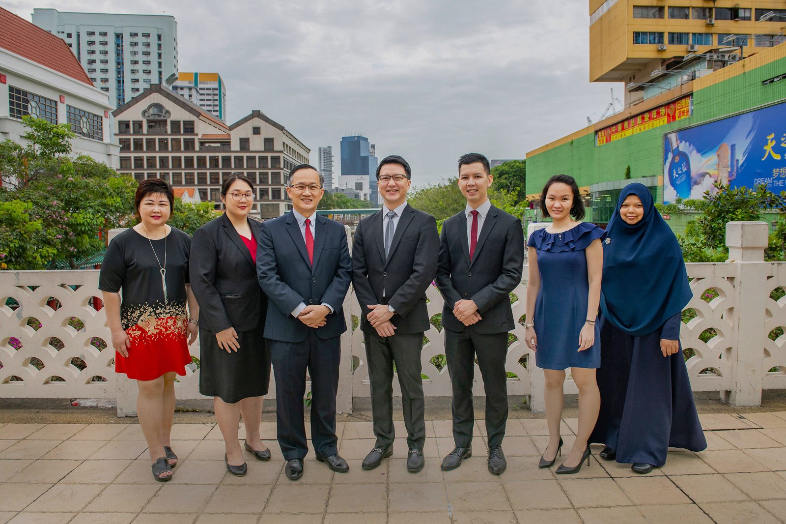 The BC Lim & Lau LLC team standing together on a terrace in Chinatown